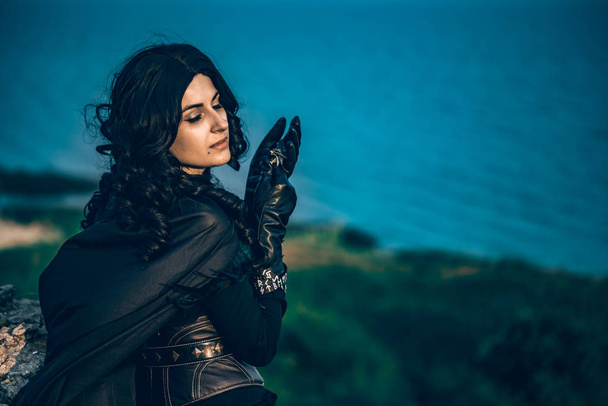 Fantasy cosplay beautiful Witcher girl on cliff - Photo, Image