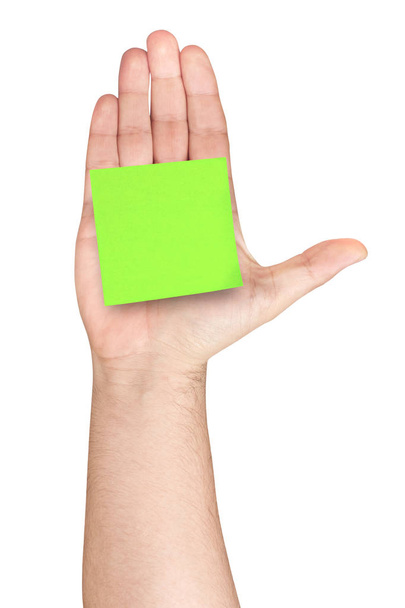 Postit verde en blanco pegado en la palma de la mano masculina de la mano para arriba aislado
 - Foto, Imagen
