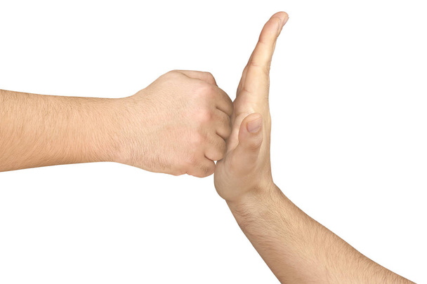Flat hand opposing and stopping clenched fist isolated - Photo, Image