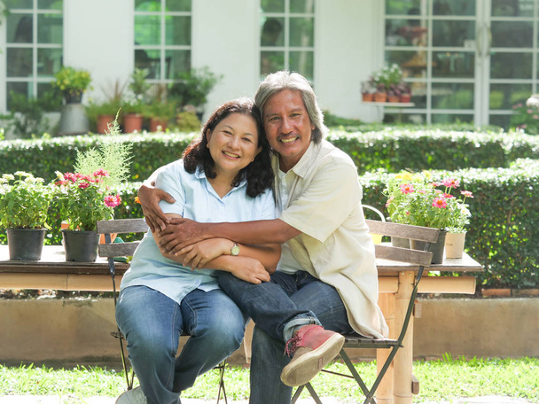 Senior couple laughing together in home garden. - Foto, Imagem