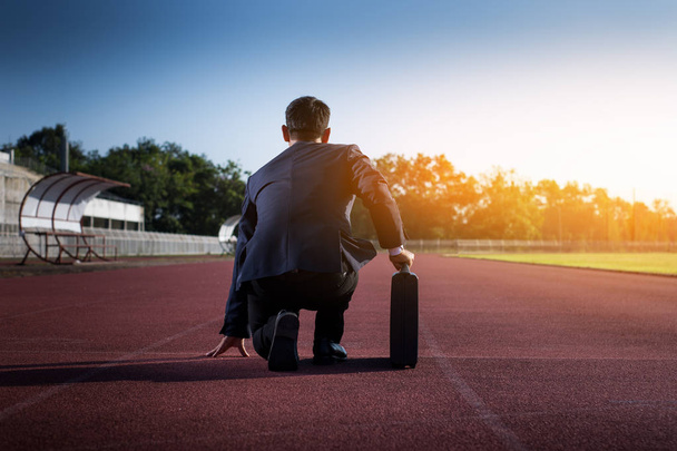 A businessman on a track ready for race in business - Photo, Image