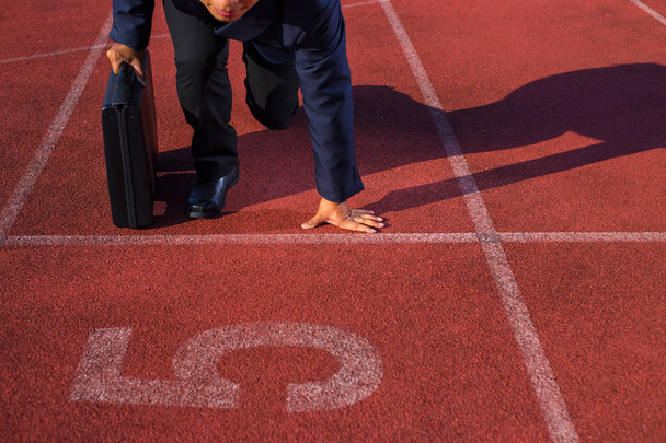 A businessman on a track ready for race in business - Photo, Image