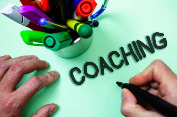 Text sign showing Coaching. Conceptual photo Prepare Enlightened Cultivate Sharpening Encourage Strenghten Man holding black marker white background markers intention communicate - Photo, Image