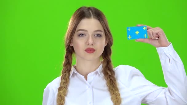 Schoolgirl shows a finger down . Green screen - Materiał filmowy, wideo