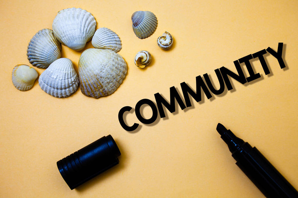 Conceptual hand writing showing Community. Business photo text Neighborhood Association State Affiliation Alliance Unity Group Yellow background shadow open marker shells beach memory memories - Photo, Image