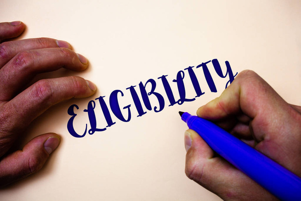 Conceptual hand writing showing Eligibility. Business photo showcasing State of having the right for doing or obtain something Proper Man holding blue marker white background ideas inspiration - Photo, Image