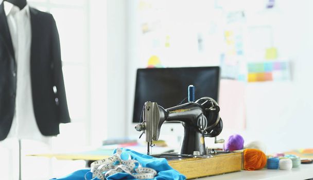 Retro sewing machine on designer clothes desktop - Fotografie, Obrázek
