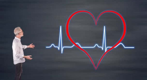 Businessman showing a heart beats graph on a wall screen - Photo, Image
