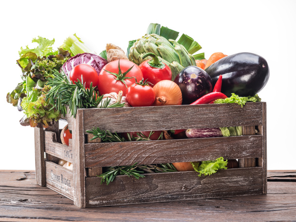 Fresh multi-colored vegetables in wooden crate. - Photo, Image