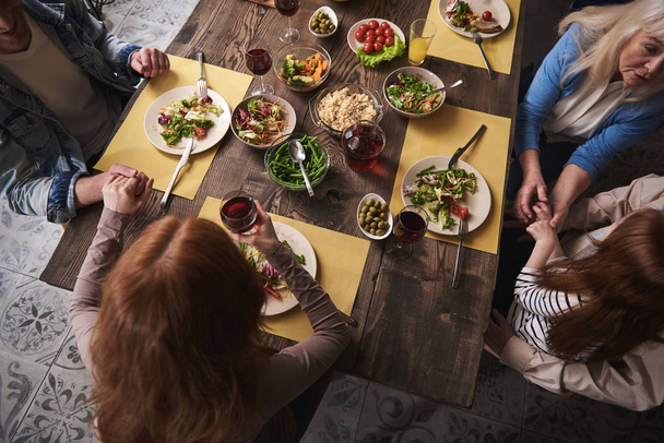 Family eating wholesome meal and talking at home - Fotoğraf, Görsel