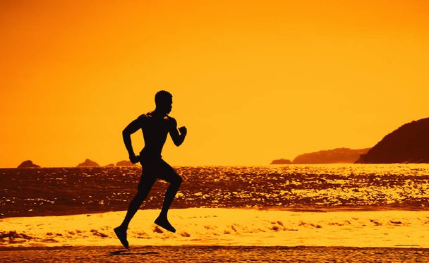 Silhouette of a runner at sunset outdoor with copy space as symbol for sport - Fotografie, Obrázek