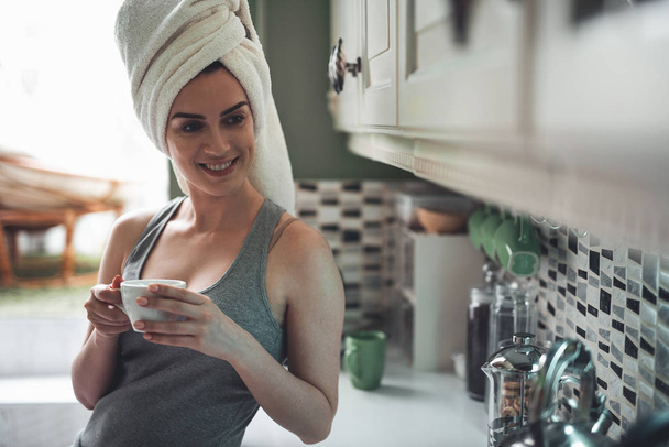 Satisfied girl drinking coffee after shower - Фото, изображение