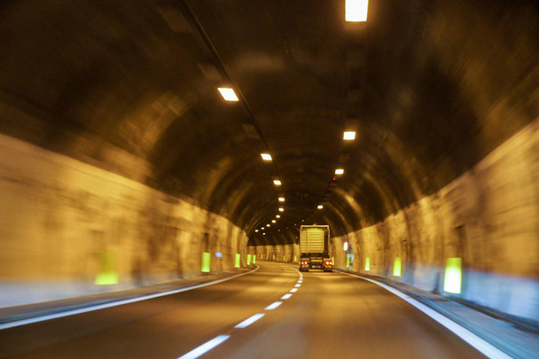 Driving by car through mountain tunnels. - Фото, изображение