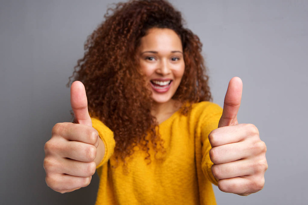 Portrait of happy african american woman smiling with thumbs up  - Foto, imagen