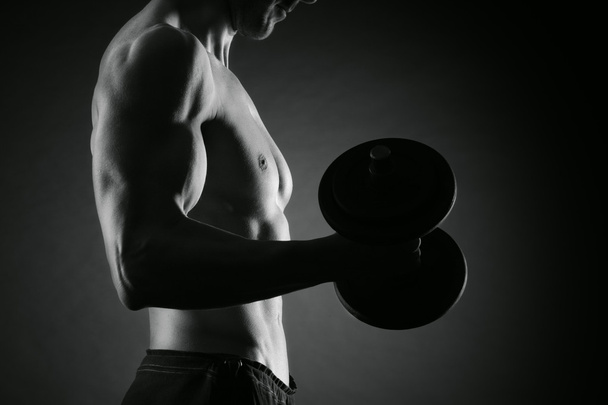 Exercising biceps with dumbbells - Φωτογραφία, εικόνα