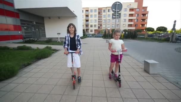 Happy Kids Are Riding On Kick Scooter Outdoor. They Have A Lot of Fun Playing Together. - Imágenes, Vídeo