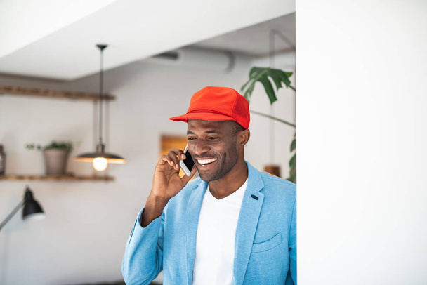 Positive african man speaking by phone - Foto, immagini