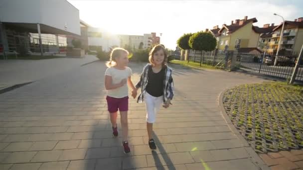 Boy And Girl Run Together Holding Hands On Asphalt. They Have A Lot of Fun. - Video, Çekim