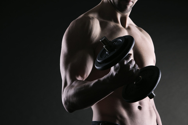 Exercising biceps with dumbbells - Photo, image