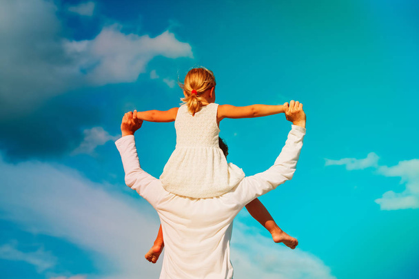 Père et petite fille jouent au ciel
 - Photo, image