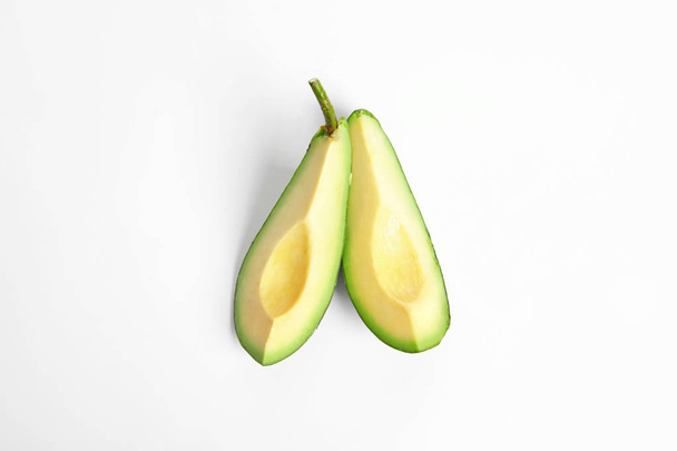 Slices of avocado on white background - Foto, immagini