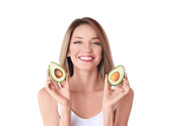 Portrait of young beautiful woman with ripe delicious avocado on white background - Valokuva, kuva