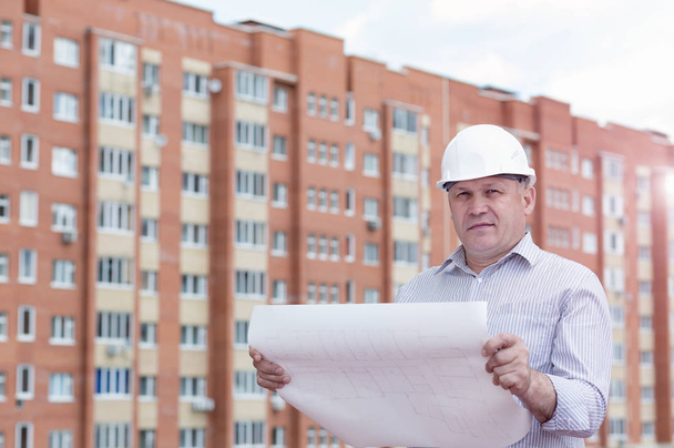 An engineer with construction plans - Fotografie, Obrázek