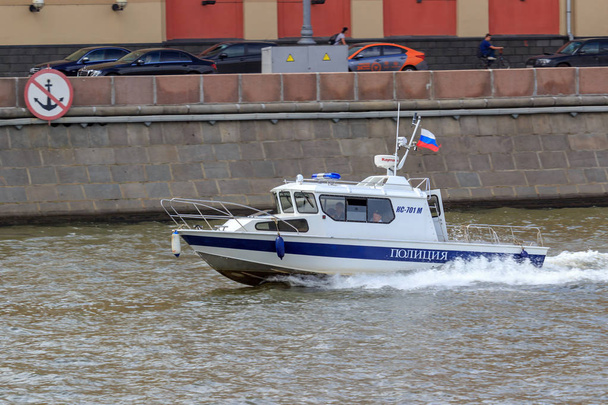Moscow, Russia - June 21, 2018: Police boat rushing on a background of Moskva river embankment on a summer day - Photo, image