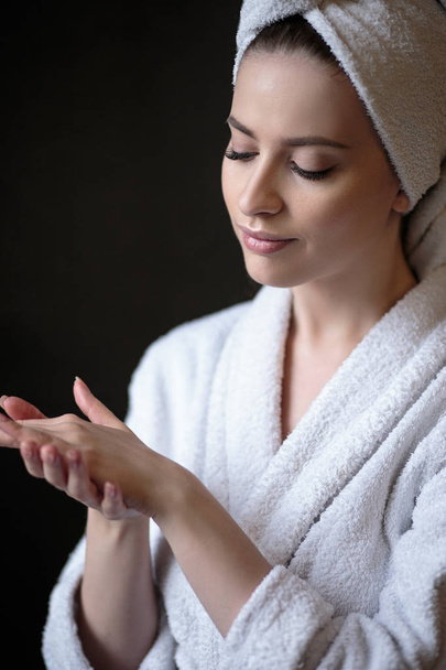 Young woman in a bathrobe and towel on her head, spa and care portrait, clean natural face - Photo, image