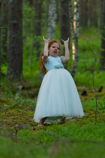 Little emotional girl in a princess dress in a summer forest, natural light - Fotó, kép