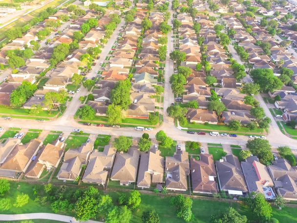 Aerial view huge park near residential houses in Houston, Texas, USA. Green urban recreation with long pathway surrounds with green tree. Tightly packed homes neighborhood and driveways flyover - Photo, Image
