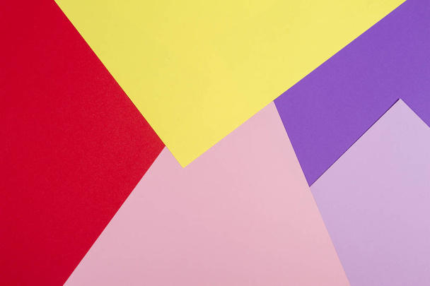 Color papers geometry flat composition background with violet, purple, pink, red, yellow tones. - Foto, Bild