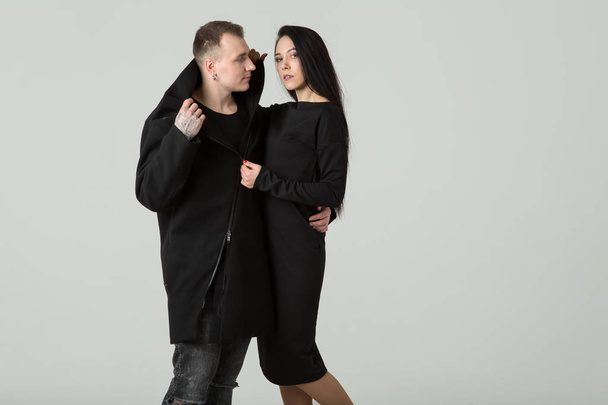 Man and woman are fashion models in dark clothes. Couple. - Фото, изображение