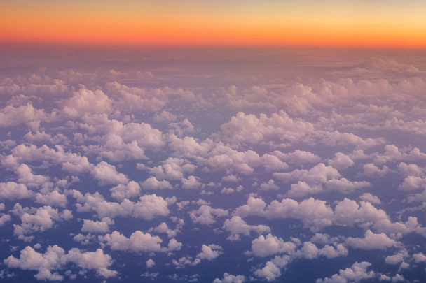 Flying above the clouds. Aerial view from the airplane - Фото, изображение