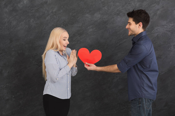 Man giving paper heart to colleague, copy space - Photo, Image