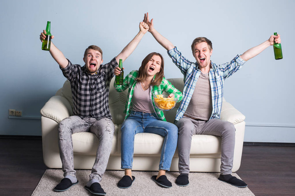 Happy friends or football fans watching soccer on tv and celebrating victory. Friendship, sports and entertainment concept - Photo, Image