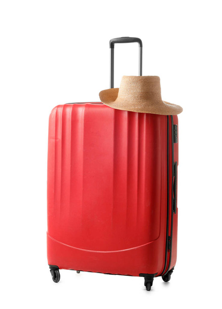 Bright red suitcase packed for journey on white background - Фото, изображение