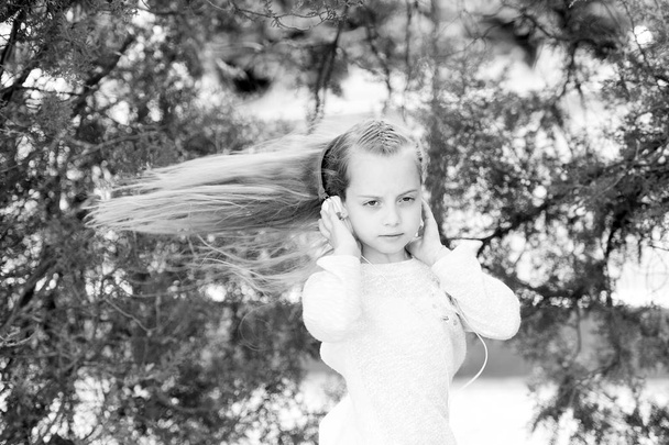 Girl dance to music in summer park. Small child enjoy music in headphones outdoor. Kid dancer with long flying hair. Melody sound and mp3. Summer fun and joy - Foto, immagini