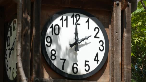 Steady shot of white round clock mounted in a wooden crate, without a second hand - Footage, Video