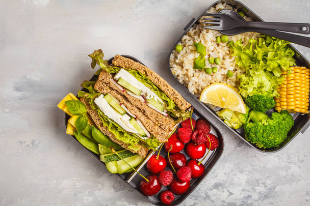 Healthy meal prep containers with feta sandwich with fruits, berries, rice and vegetables. Healthy vegetarian food concept. Takeaway food. - Fotoğraf, Görsel