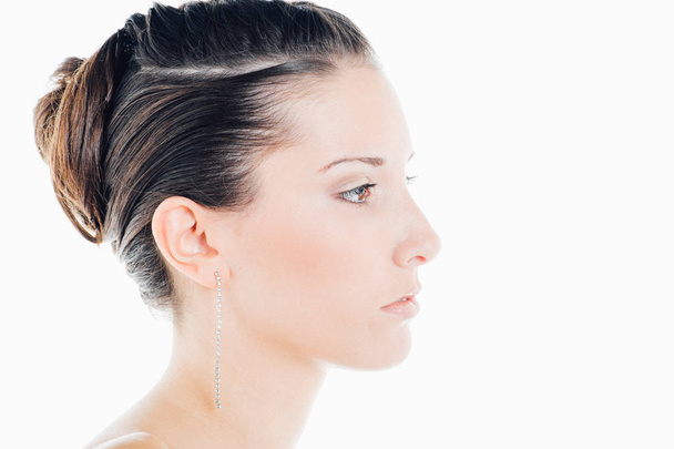 Profile of a young caucasian brunette beauty portrait in studio - Foto, Imagem