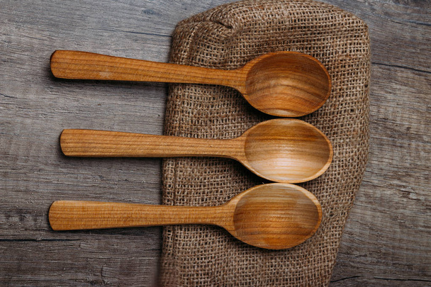 wooden spoons cutlery are on a wooden table - Fotó, kép
