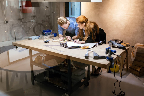 Designers working in modern office with handful of tools - Foto, afbeelding