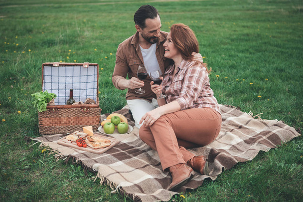 Glad married couple having picnic on holiday in the nature  - Valokuva, kuva
