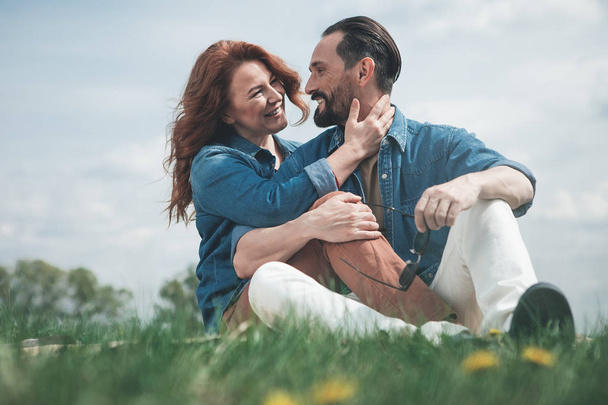 Glad loving couple relaxing on the meadow  - Photo, Image