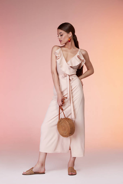 Sexy elegant woman natural beauty fashion style clothes casual formal silk beige dress lady romantic meeting date party style glamour model dark hair brunette makeup accessory bag earrings shoes. - 写真・画像