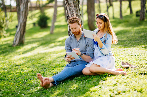 Beautiful couple studying together for exams in nature - Foto, Bild