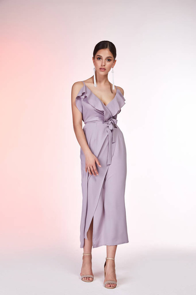 Pretty beautiful sexy elegance woman skin tan body fashion model glamor pose wear silk lilac dress casual clothes party summer collection makeup hair style brunette success accessory jewelry studio. - Photo, image
