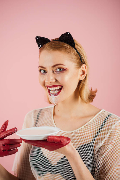 Cat woman eat sour cream. cat woman with happy face eat milk. - Foto, afbeelding