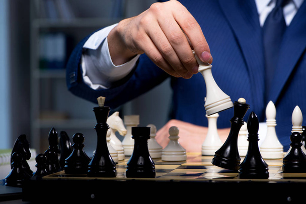 Businessman playing chess in strategy concept - Foto, immagini
